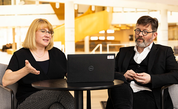 Two people looking at a computer screen