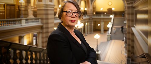 Carina Burman står i universitetshusets hall.