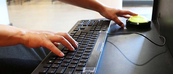 two hands holding a computer mouse and a keyboard.