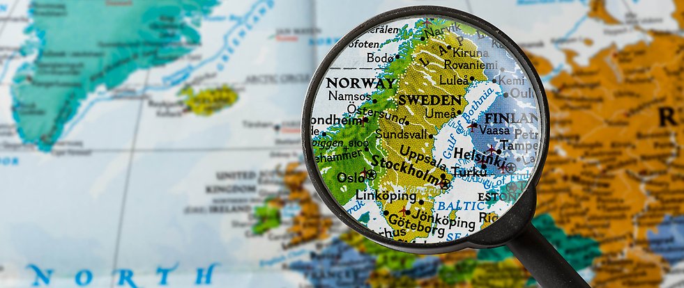 A magnifying glass held over Sweden on a map